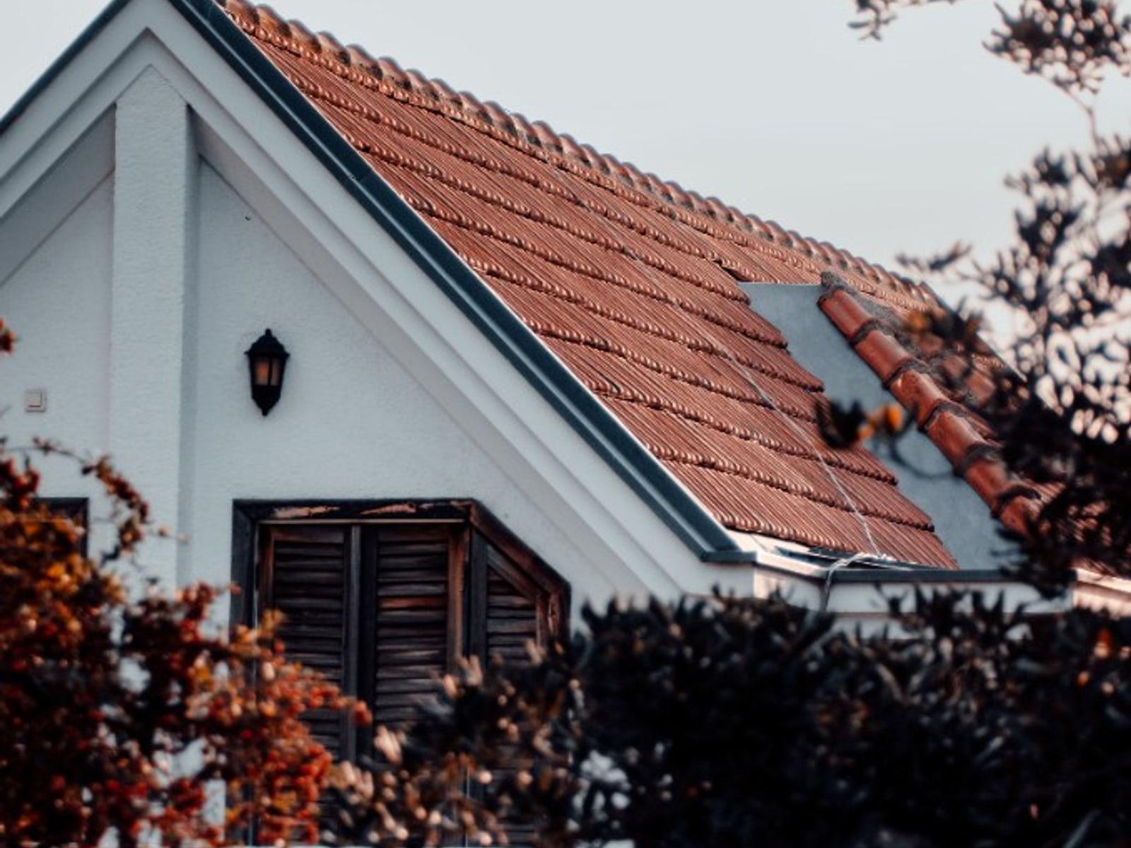 White gabled building finished with clay roof tiles in Thrissur